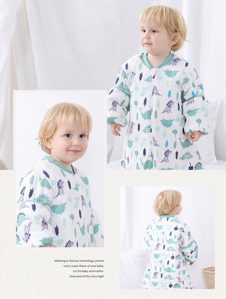 Baby wearing Dear Kora cotton sleeping sack in Jurrasic pattern.