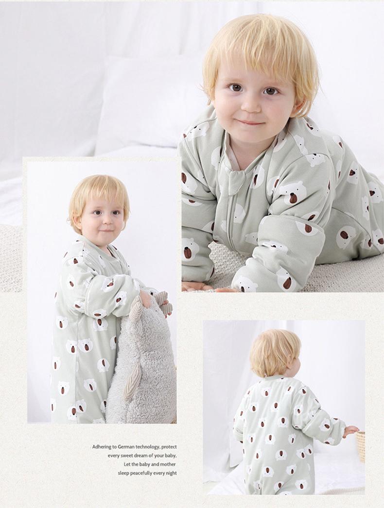 Baby wearing Dear Kora cotton sleeping sack in minty bear pattern.