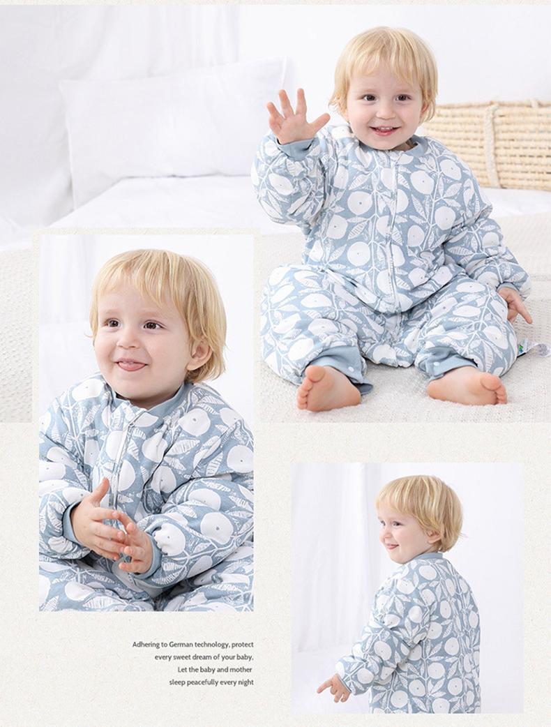Baby wearing Dear Kora cotton sleeping sack in blue berry pattern.
